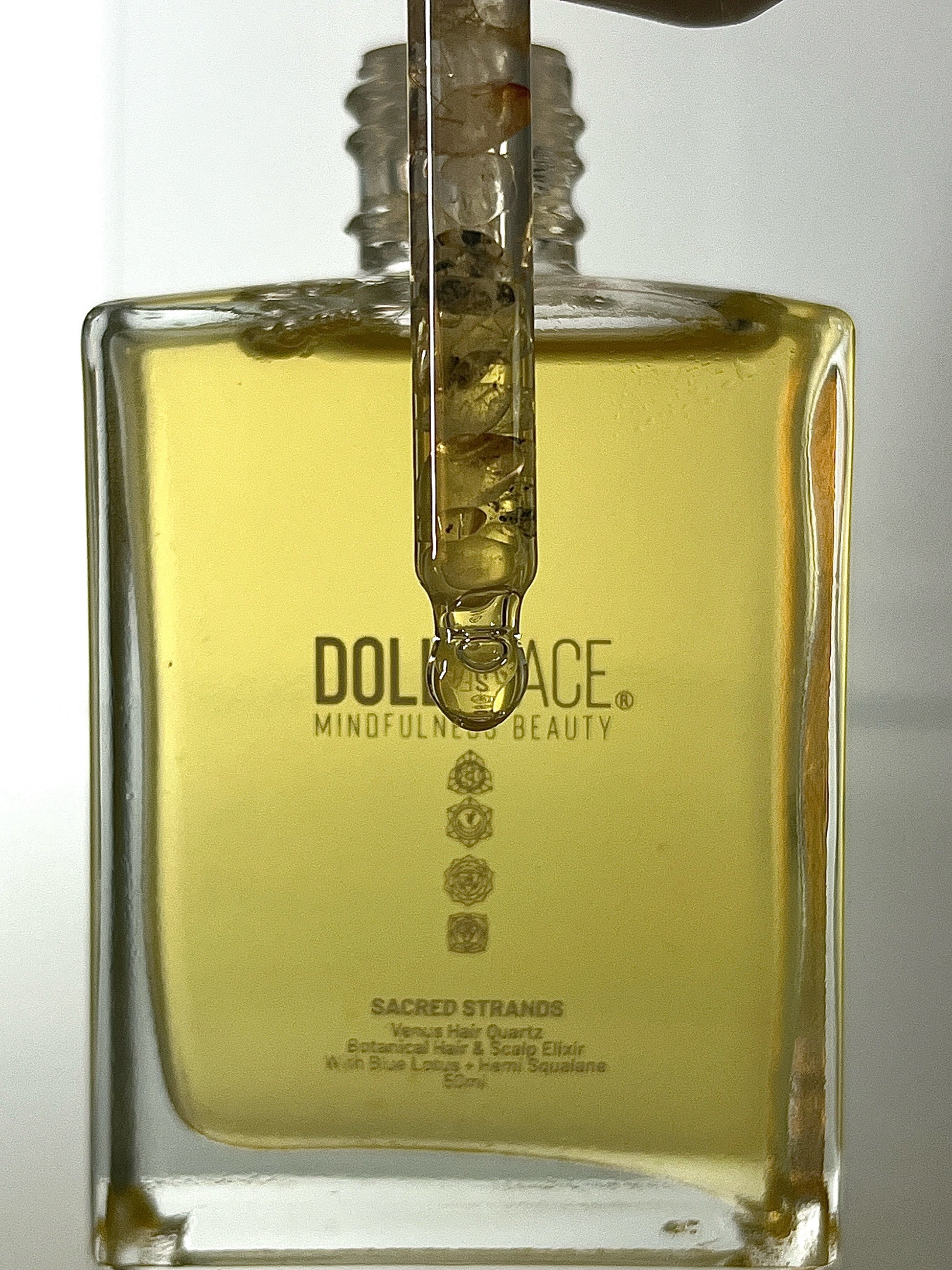 Sacred Strands 50 ML glass bottle with Venus Hair Quartz crystal in pipette, containing luxurious Blue Lotus and Hemi-Squalane oil