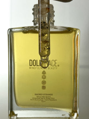 Sacred Strands 50 ML glass bottle with Venus Hair Quartz crystal in pipette, containing luxurious Blue Lotus and Hemi-Squalane oil