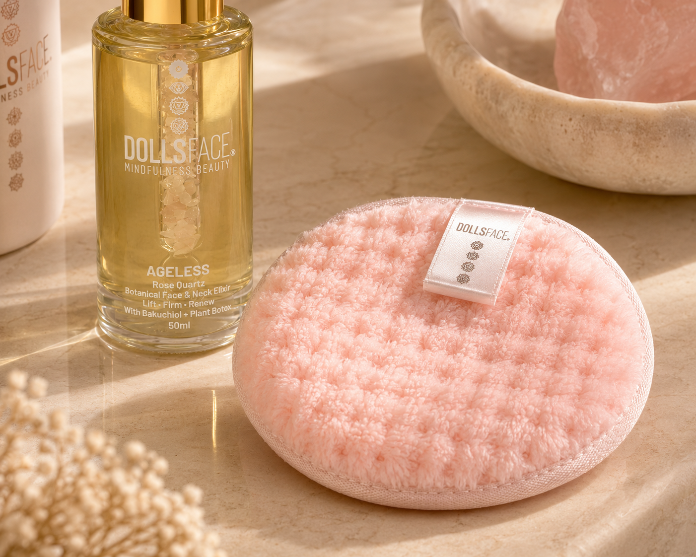 DOLLSFACE® HALO facial cleansing pad alongside AGELESS Rose Quartz Botanical Face & Neck ELIXIR.