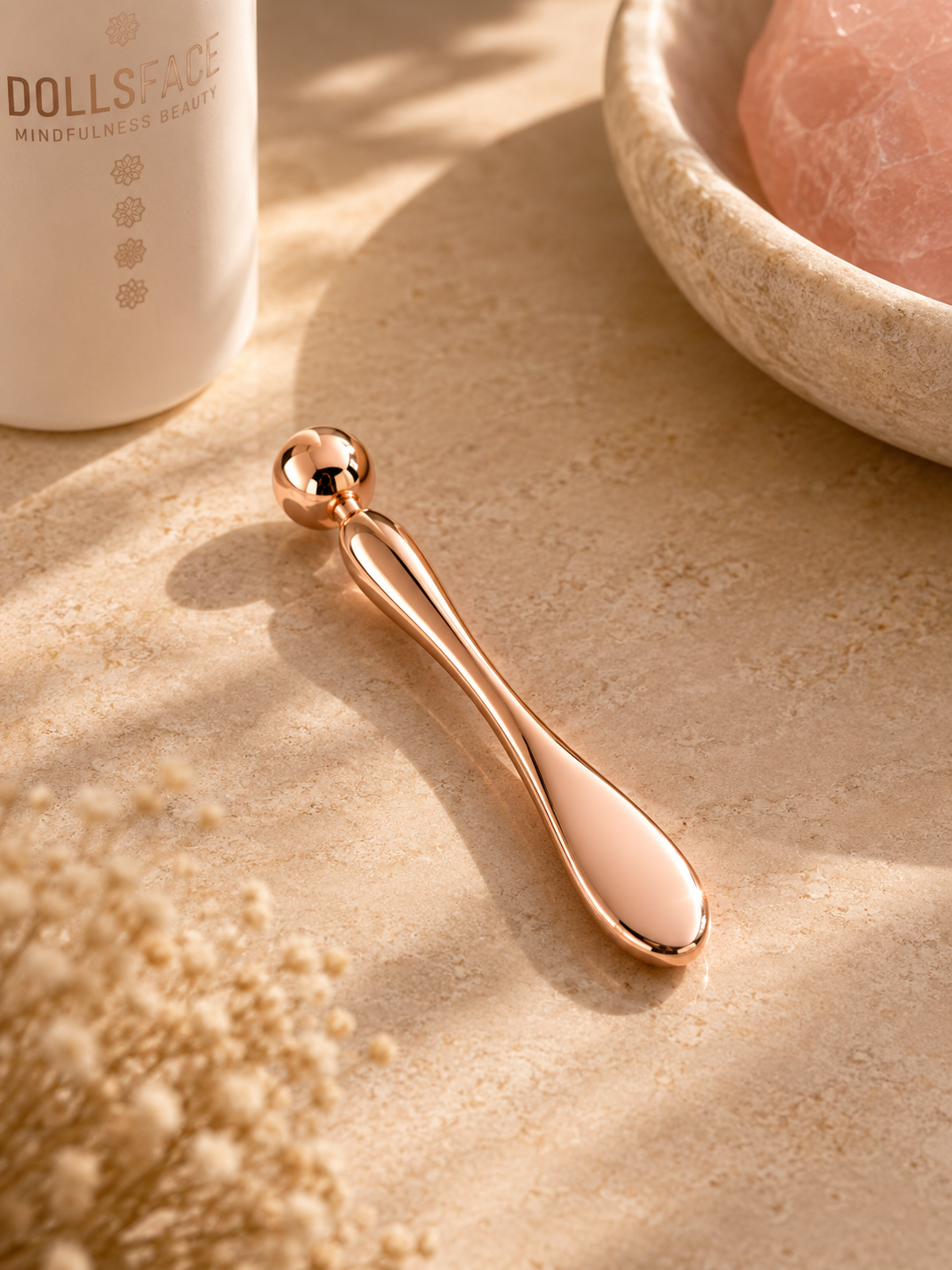 DOLLSFACE® rose gold Precision Ritual Bar with rounded tip for targeted facial massage.